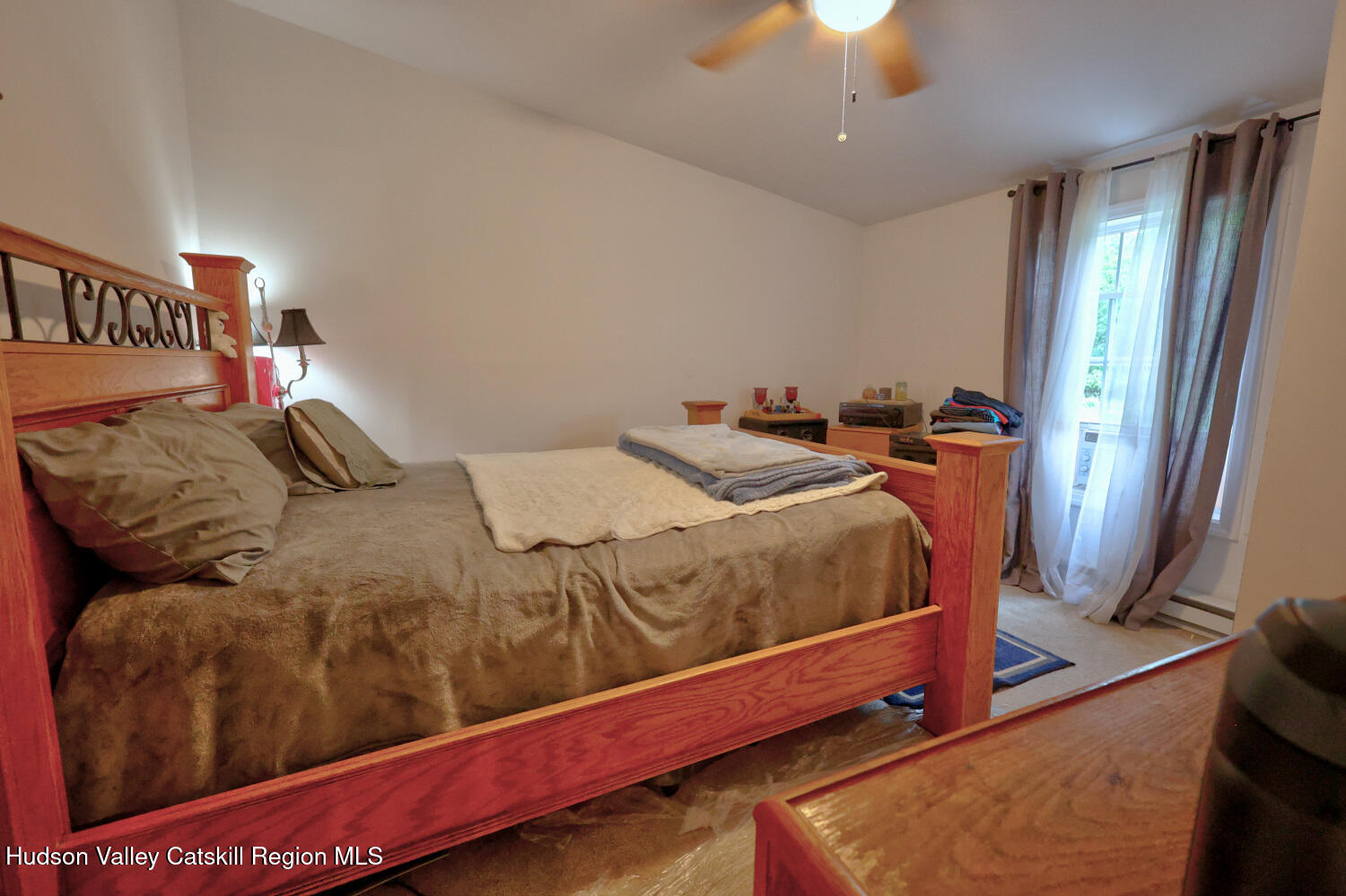 141 Jones Road Round Top, NY 12473 - Photo 27 of 70 a bedroom with a bed and a chandelier