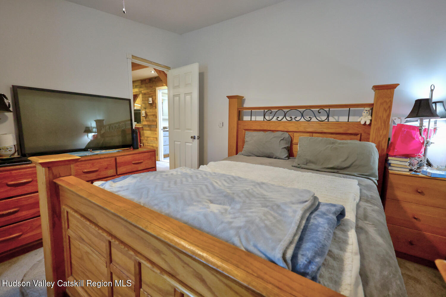 141 Jones Road Round Top, NY 12473 - Photo 29 of 70 a bedroom with a bed and a flat screen tv