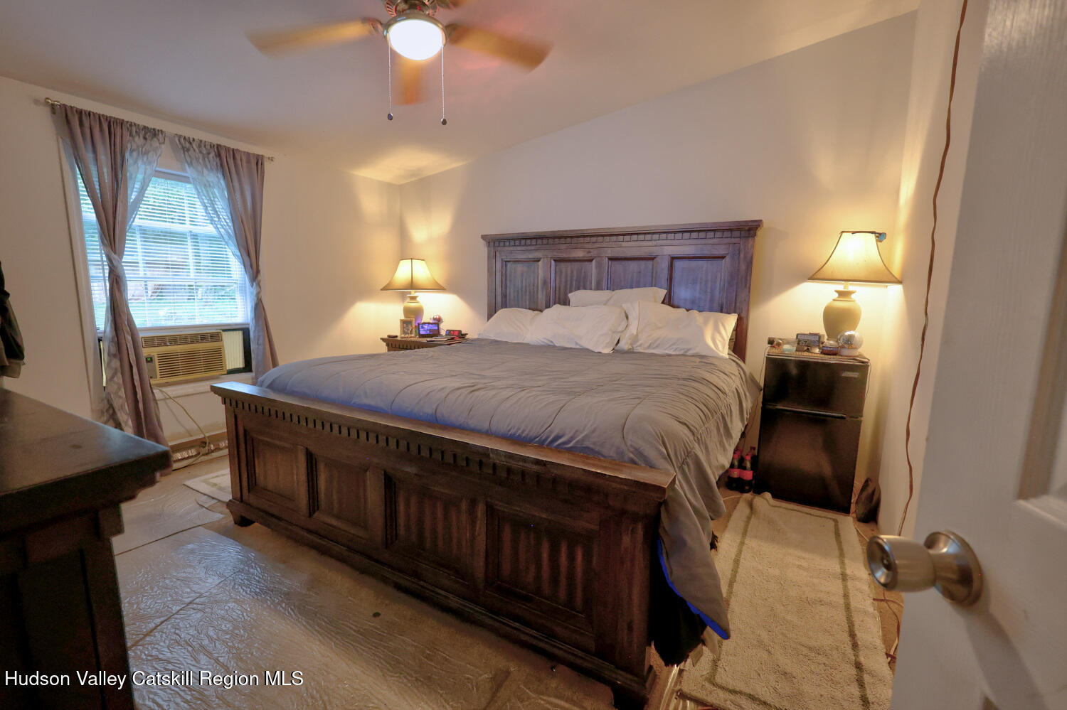 141 Jones Road Round Top, NY 12473 - Photo 32 of 70 a bedroom with a bed and a chandelier