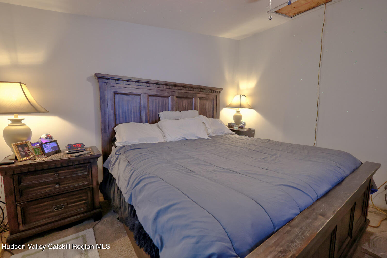 141 Jones Road Round Top, NY 12473 - Photo 33 of 70 a bedroom with a bed and a lamp