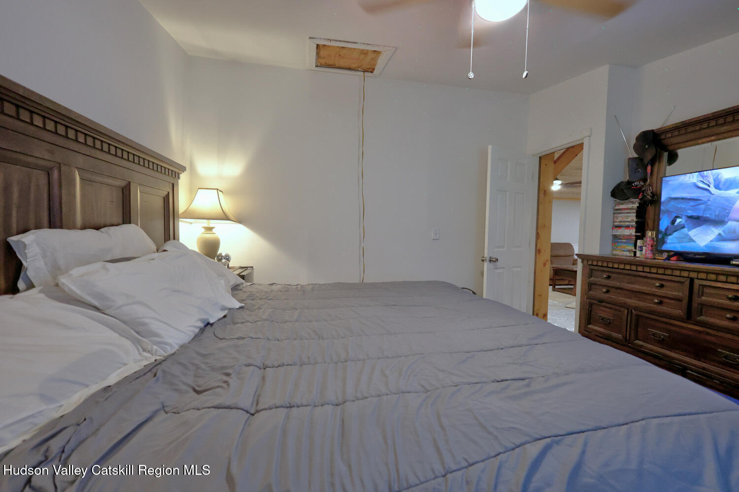 141 Jones Road Round Top, NY 12473 - Photo 34 of 70 a bedroom with a large bed and a flat tv screen on dresser