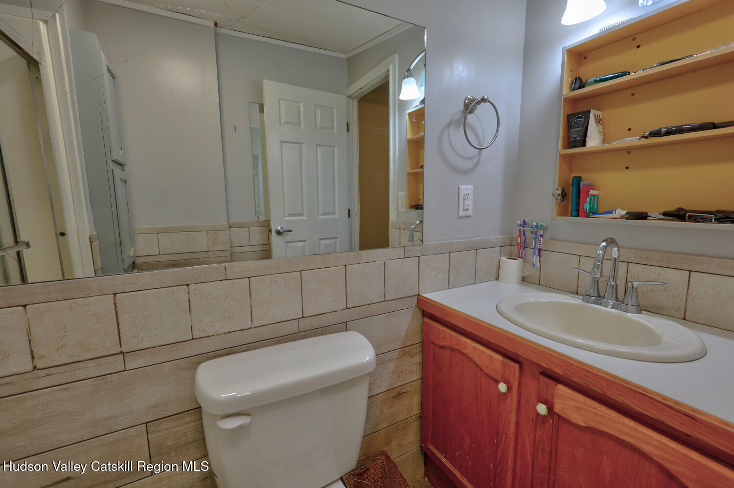 141 Jones Road Round Top, NY 12473 - Photo 42 of 70 a bathroom with a toilet a sink a mirror and vanity