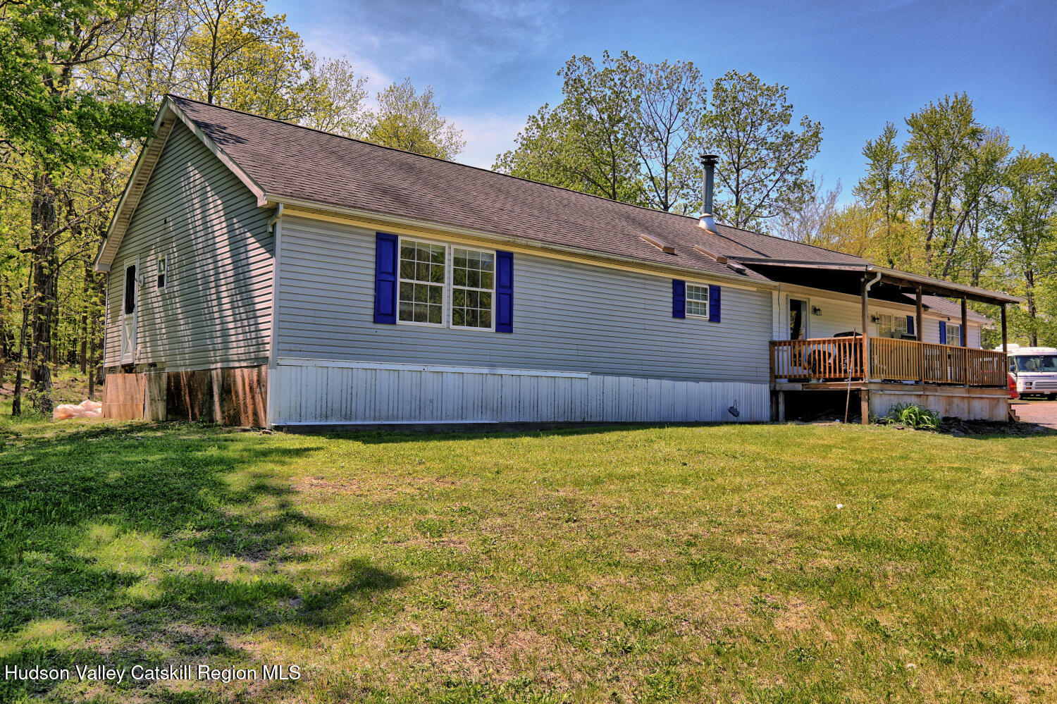 141 Jones Road Round Top, NY 12473 - Photo 69 of 70 a backyard of a house with large trees and wooden fence