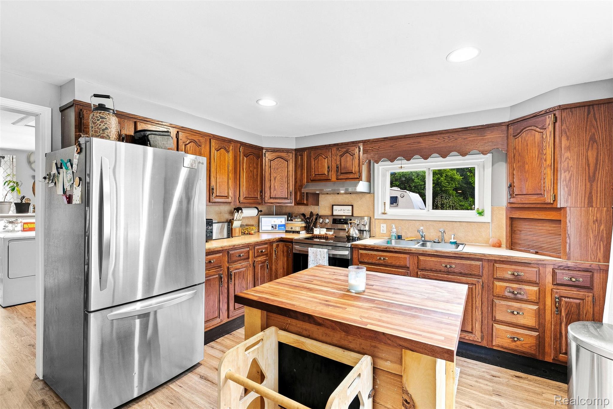 3319 Valentine Road Lapeer, MI 48446 - Photo 13 of 39 Wood-finish flooring with a central wood butcher block island
