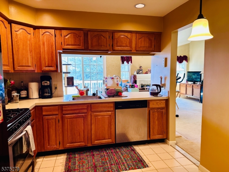 70 Boulder Run Road Paterson, NJ 07501 - Photo 12 of 29 a kitchen with stainless steel appliances granite countertop a stove a sink dishwasher and cabinets with wooden floor