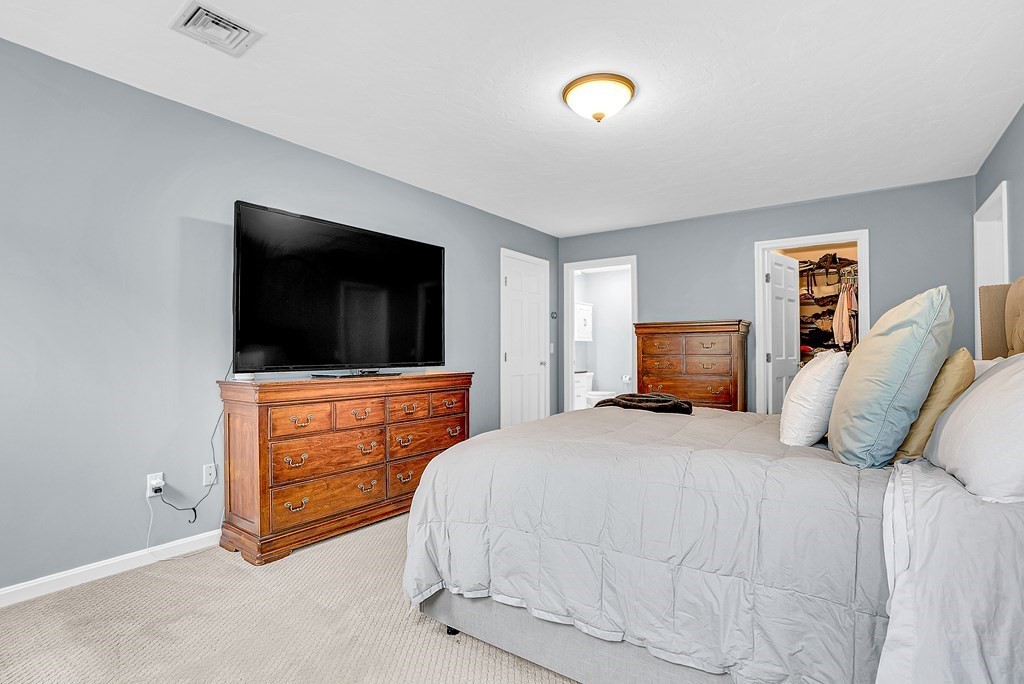 41 South Street Upton, MA 01568 - Photo 22 of 41 a bedroom with a bed and a flat screen tv