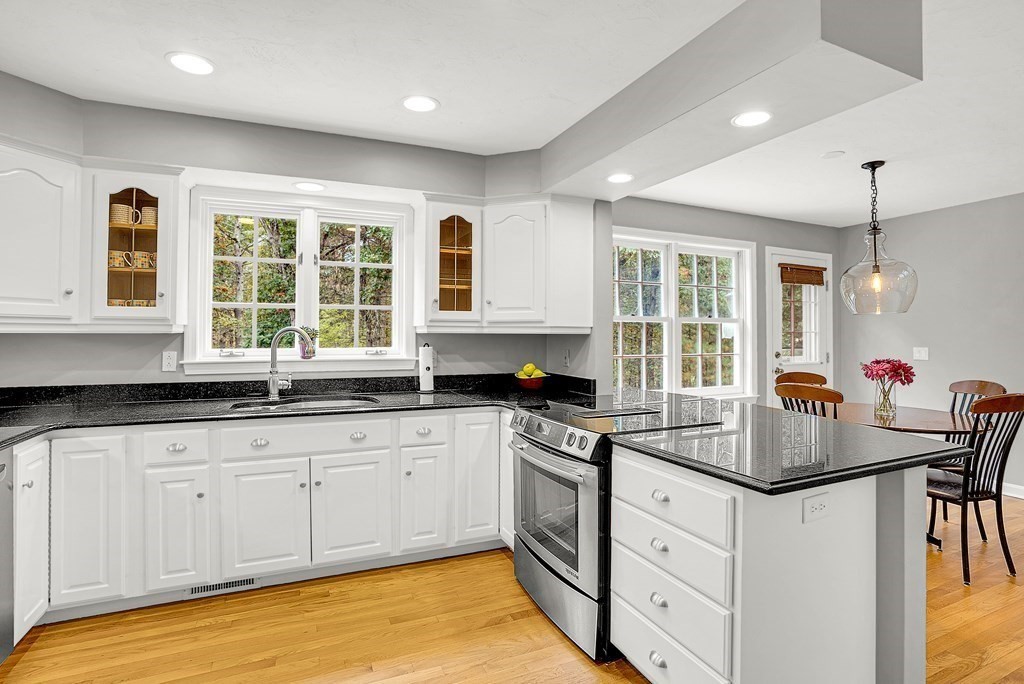 41 South Street Upton, MA 01568 - Photo 9 of 41 a kitchen with granite countertop a sink and white cabinets