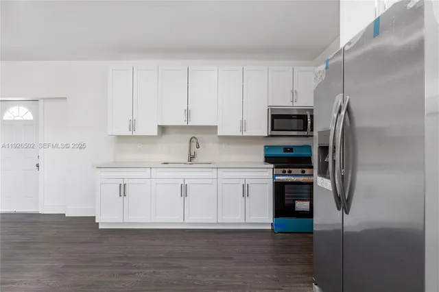 a kitchen with cabinets stainless steel appliances and a counter space