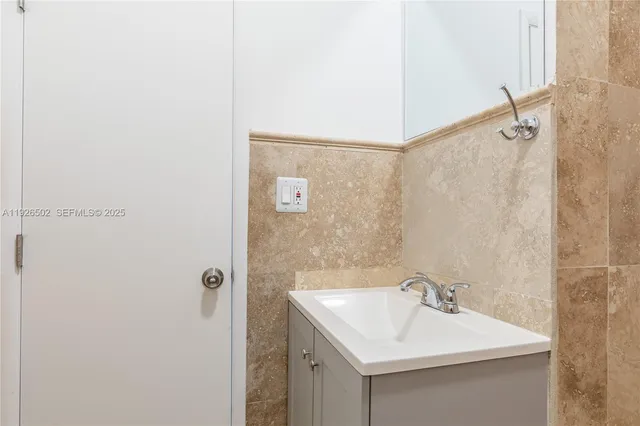 a bathroom with a sink mirror and vanity