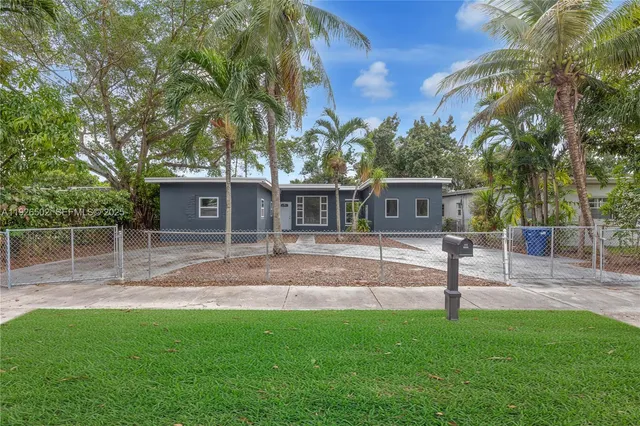 a view of a yard with a house and a tree
