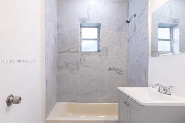 a bathroom with a sink a bath tub and a shower