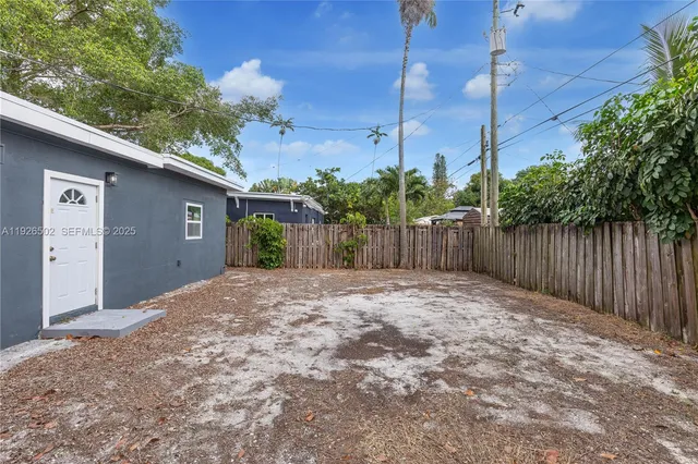 a view of backyard of house and trees