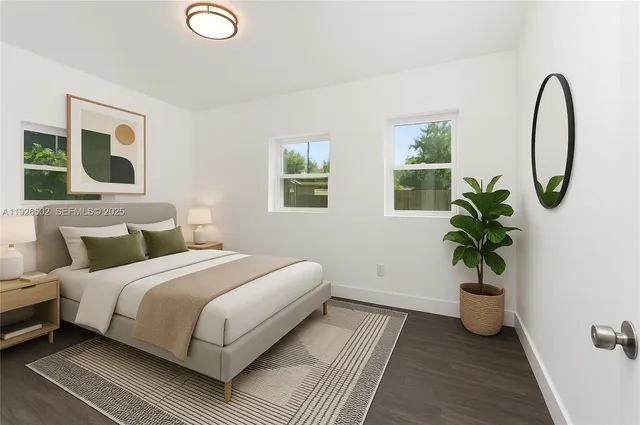 a bedroom with a bed and a potted plant