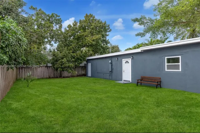 a backyard of a house with table and chairs