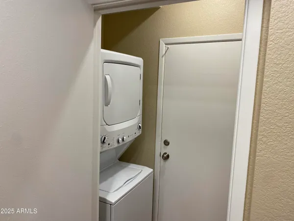 a kitchen with stainless steel appliances granite countertop a refrigerator a sink and a stove