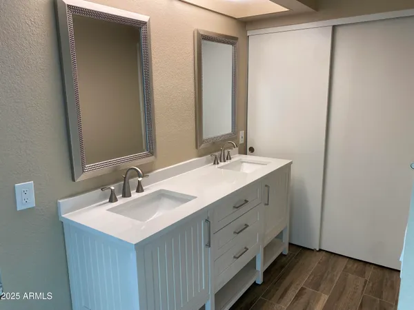 a view of a room with wooden floor