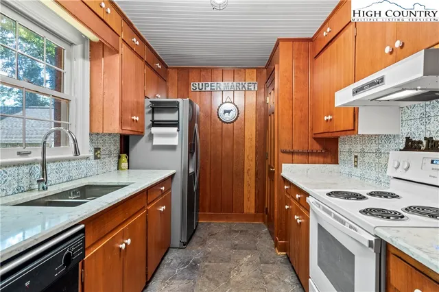 a kitchen that has a sink and a stove