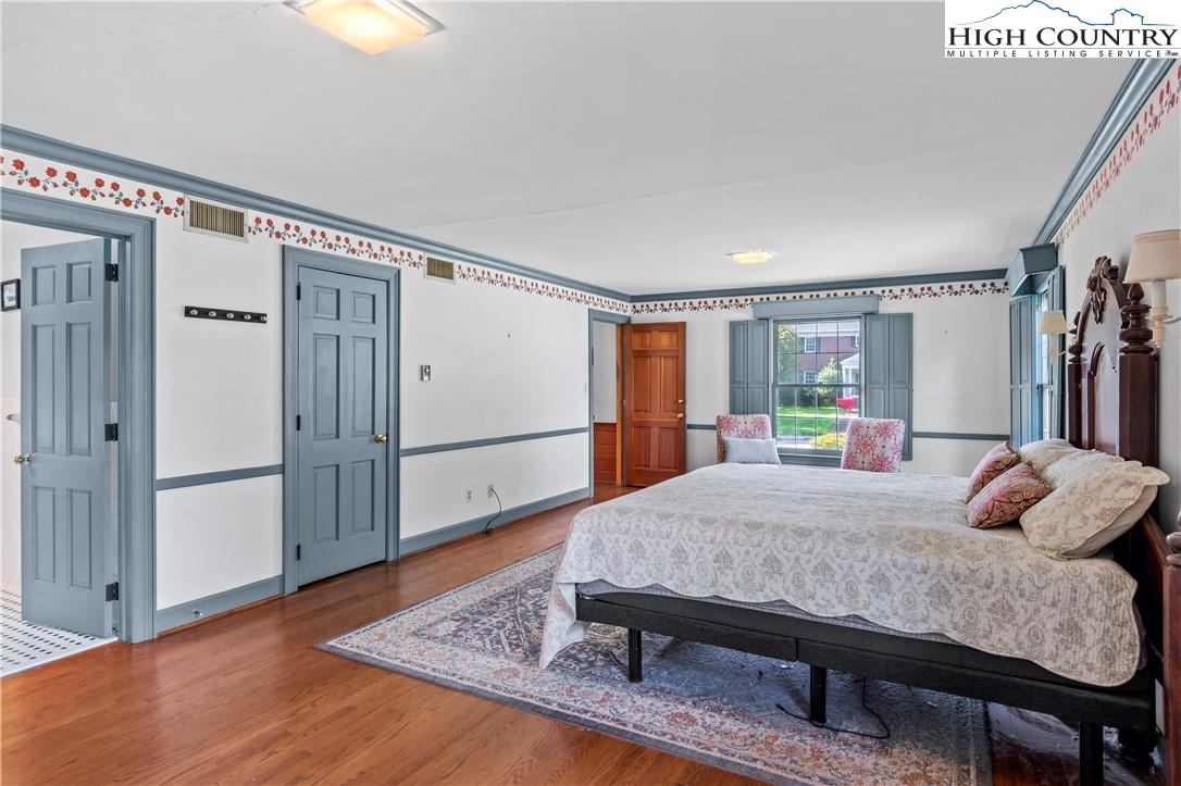 205 Hawthorne Road Elkin, NC 28621 - Photo 27 of 38 a bedroom with a bed and wooden floor