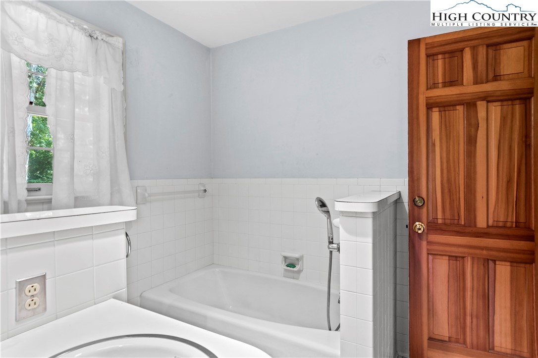 205 Hawthorne Road Elkin, NC 28621 - Photo 30 of 38 a bathroom with a bathtub and window
