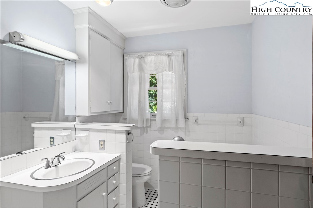 205 Hawthorne Road Elkin, NC 28621 - Photo 31 of 38 a bathroom with a sink and a mirror