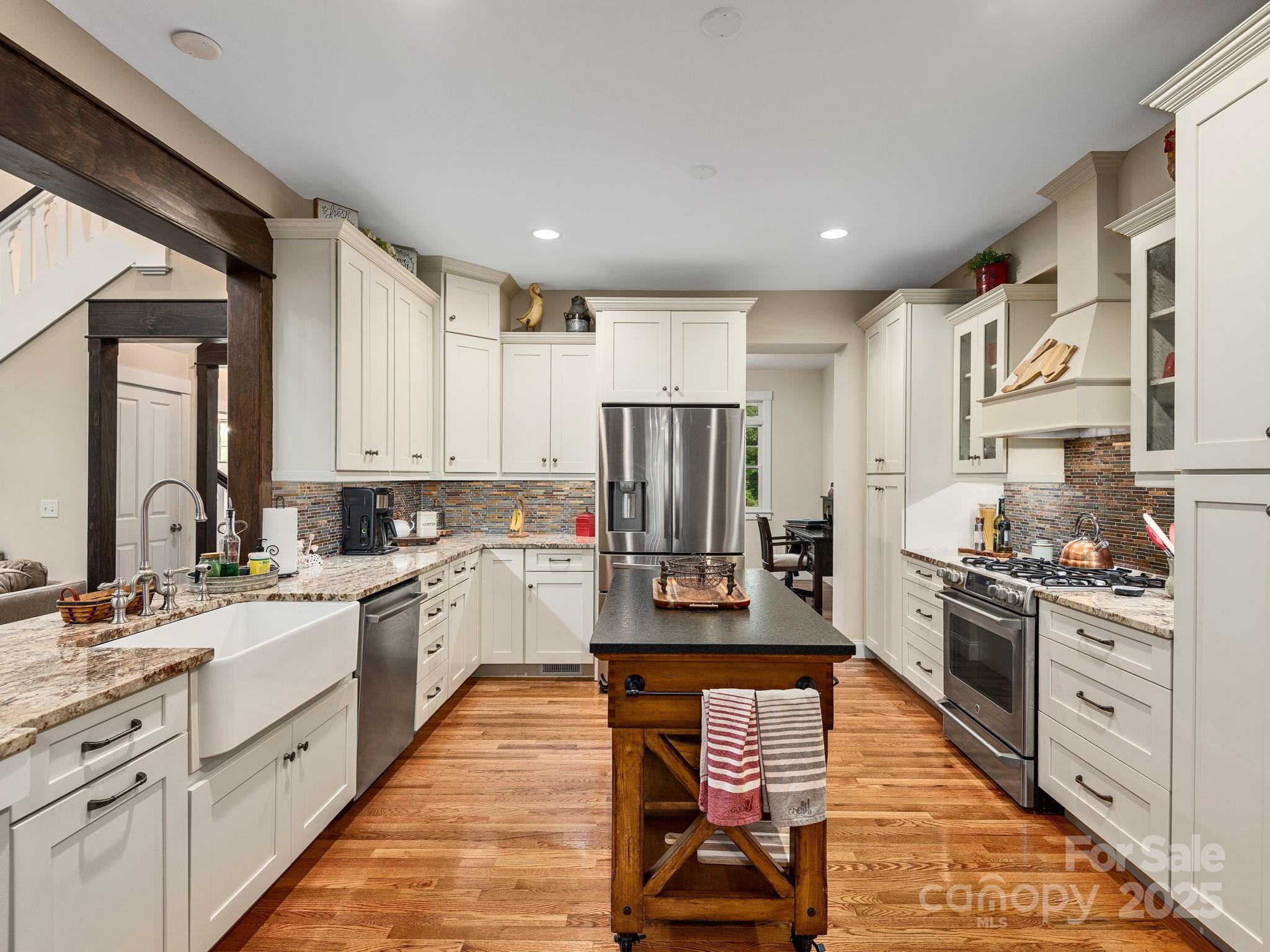 15 Avondale Road Asheville, NC 28803 - Photo 11 of 48 a large kitchen with stainless steel appliances granite countertop a stove a sink dishwasher and a refrigerator