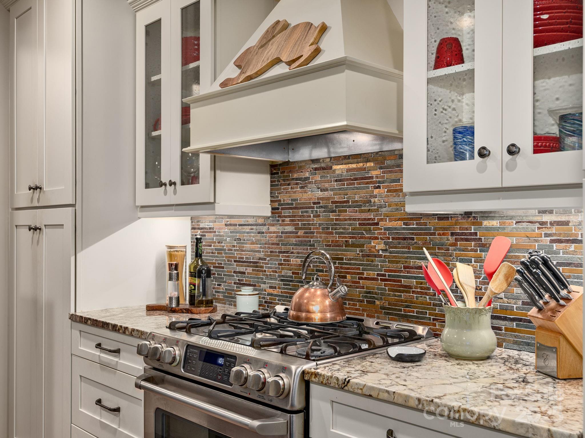 15 Avondale Road Asheville, NC 28803 - Photo 12 of 48 a kitchen with a stove and a potted plant