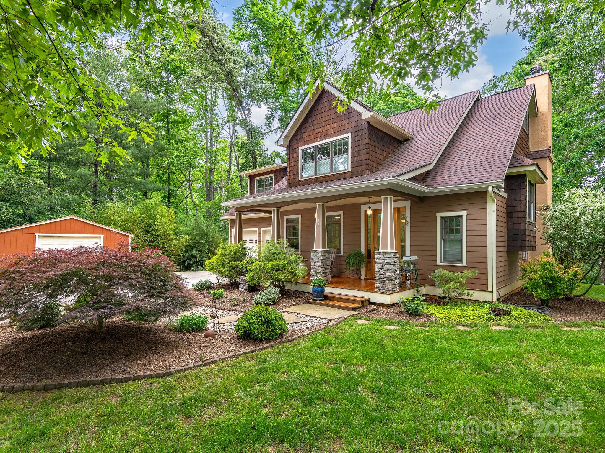 15 Avondale Road Asheville, NC 28803 - Photo 2 of 48 a patio with a table and chairs under an umbrella