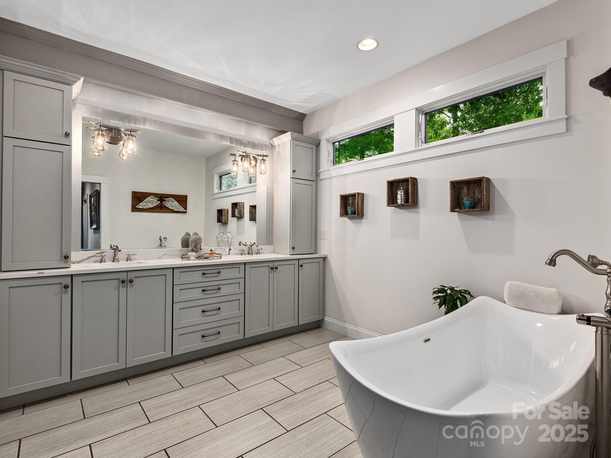 15 Avondale Road Asheville, NC 28803 - Photo 23 of 48 a spacious bathroom with a tub sink and mirror