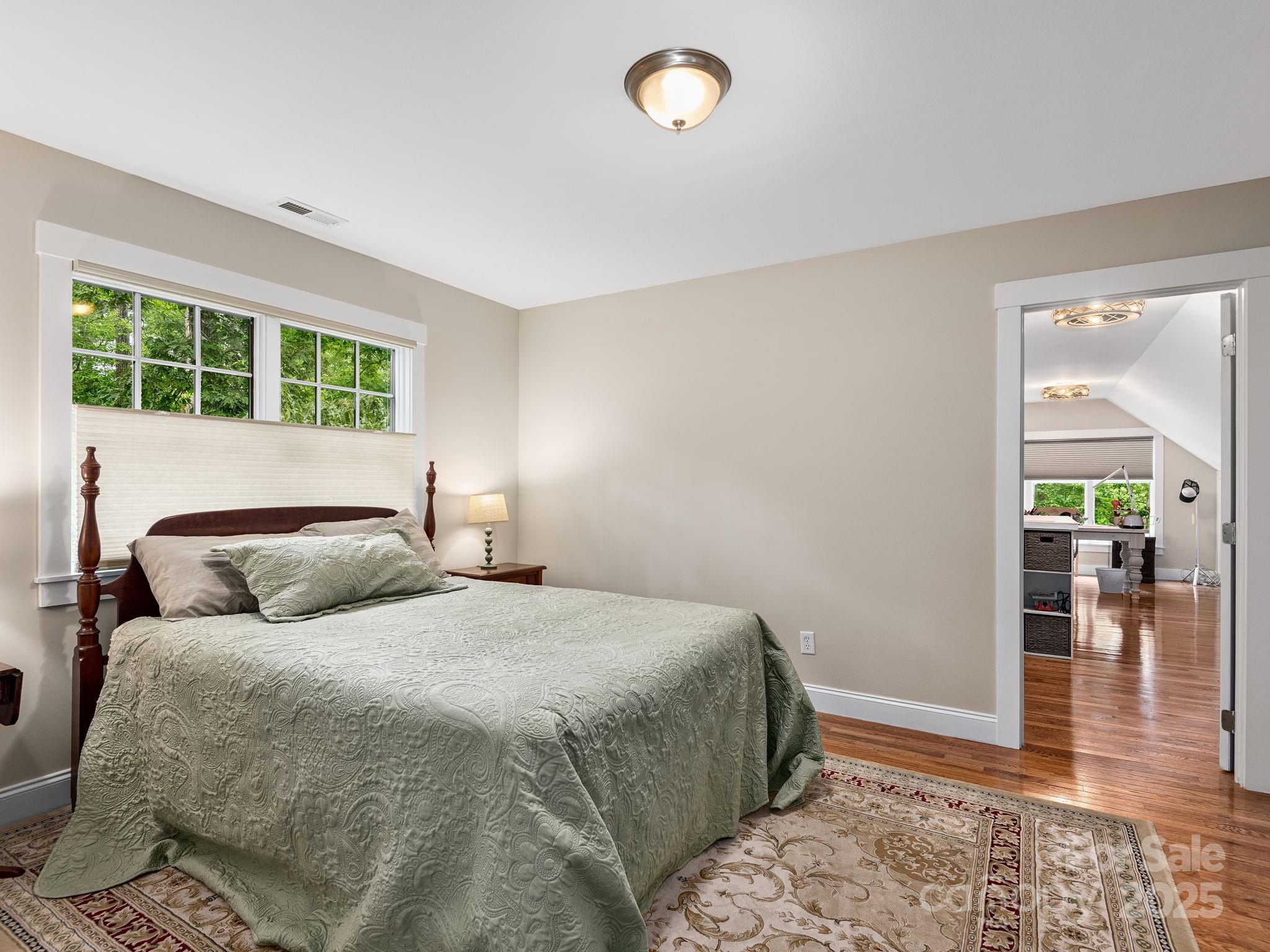 15 Avondale Road Asheville, NC 28803 - Photo 32 of 48 a bedroom with a large bed and a large window