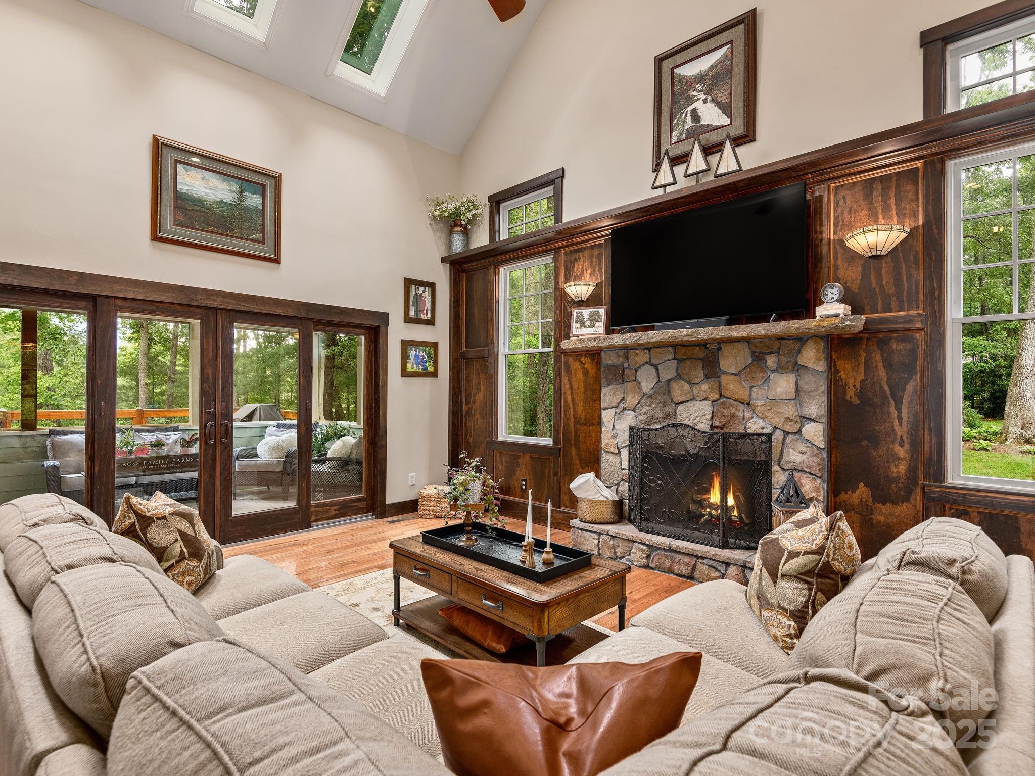 15 Avondale Road Asheville, NC 28803 - Photo 7 of 48 a living room with furniture a flat screen tv and a fireplace