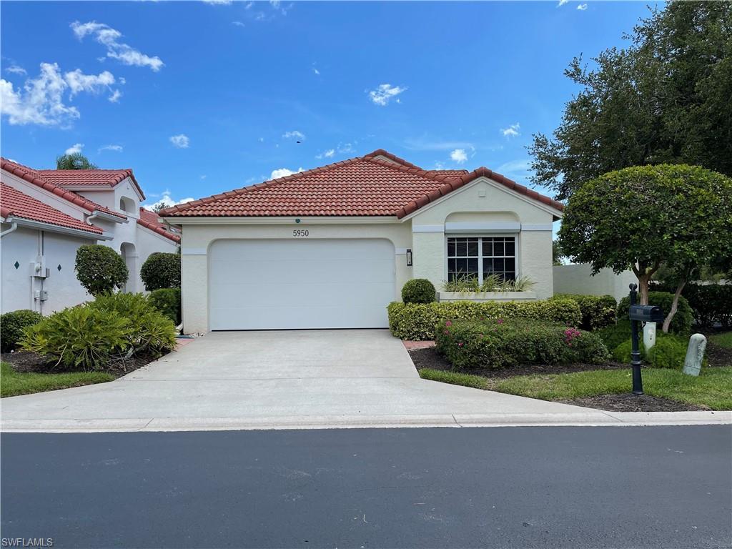 5950 Almaden Drive Naples, FL 34119 - Photo 1 of 22 a front view of a house with a yard and garage