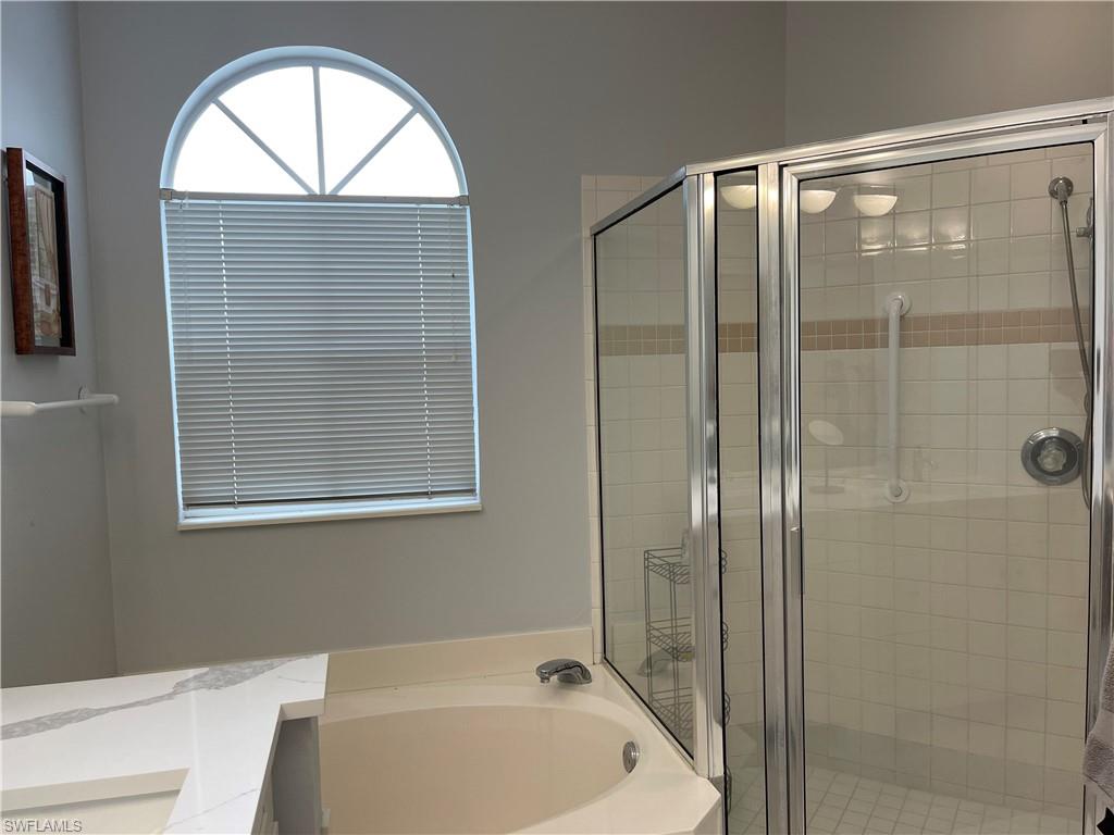 5950 Almaden Drive Naples, FL 34119 - Photo 11 of 22 a bathroom with a bathtub and a shower