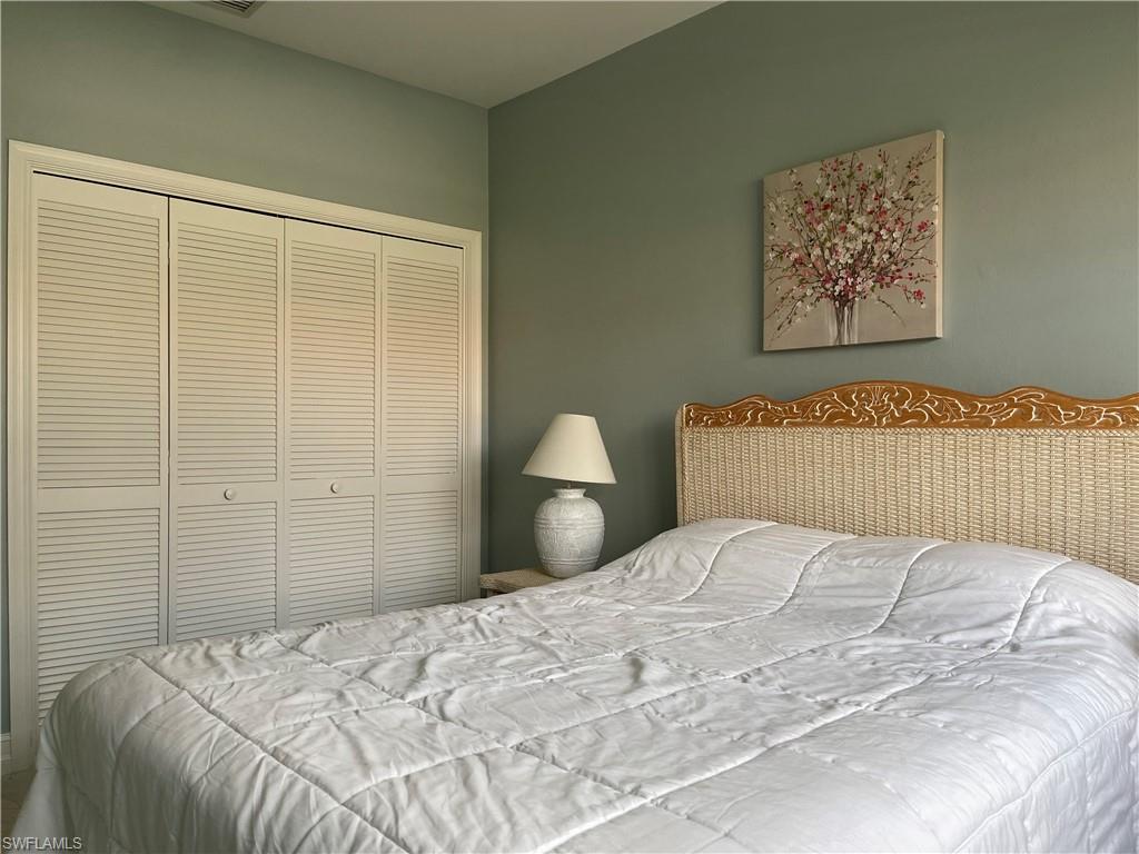 5950 Almaden Drive Naples, FL 34119 - Photo 14 of 22 a bedroom with a bed and a painting on the wall
