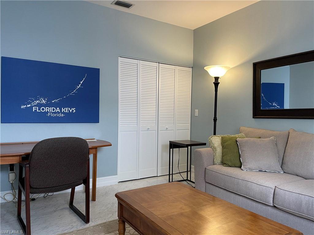 5950 Almaden Drive Naples, FL 34119 - Photo 16 of 22 a living room with furniture and a rug