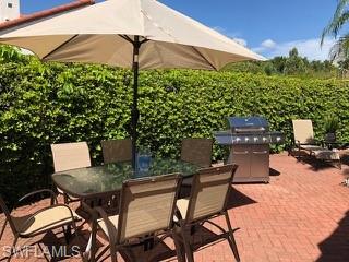 5950 Almaden Drive Naples, FL 34119 - Photo 19 of 22 a view of a chairs and table in the backyard