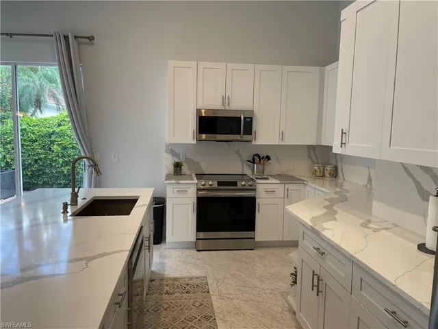 a kitchen with a stove and a sink