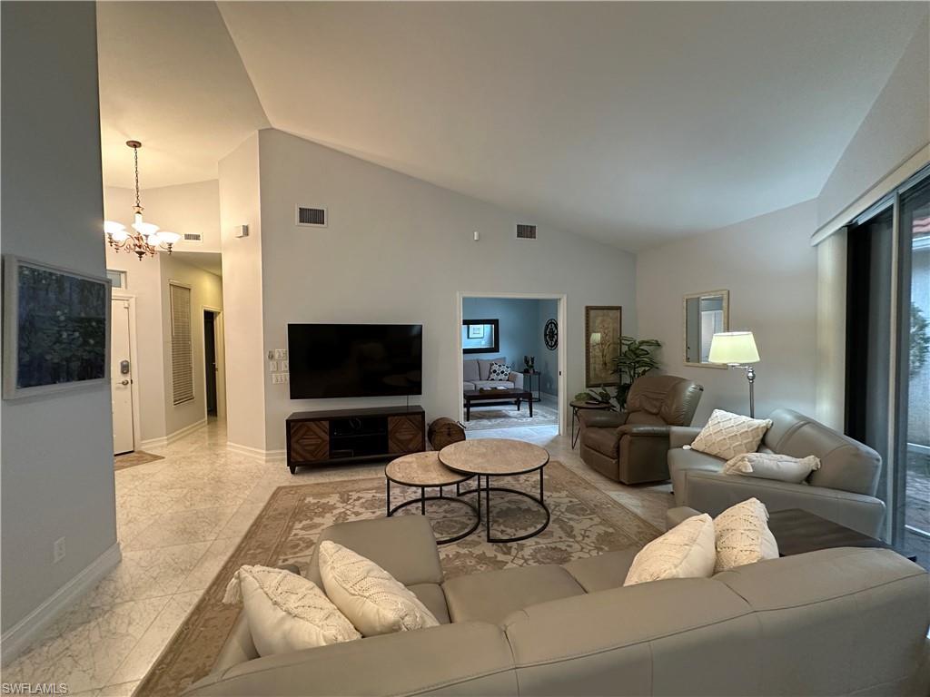 5950 Almaden Drive Naples, FL 34119 - Photo 5 of 22 a living room with furniture and a flat screen tv