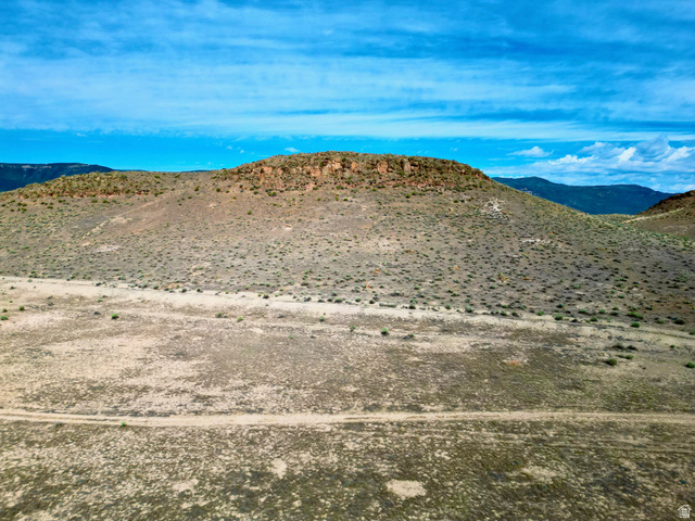 600 East E Street Moroni, UT 84646 - Photo 14 of 38 Expansive desert landscape featuring a prominent mesa with visible rock formations