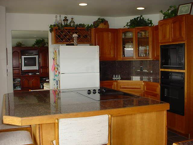 340 Black Hawk Road Yakima, WA 98908 - Photo 4 of 25 a kitchen with granite countertop a refrigerator and a stove top oven