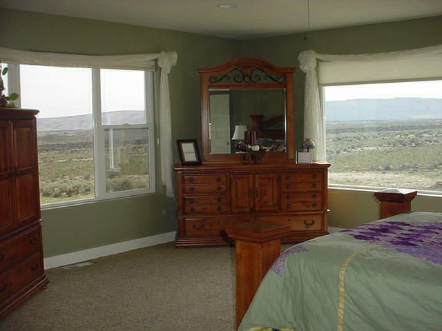 340 Black Hawk Road Yakima, WA 98908 - Photo 10 of 25 a bedroom with a bed and large windows