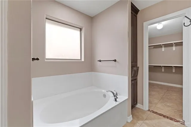 a white bath tub sitting next to a window