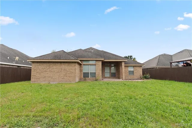 a view of a house with a yard and garage
