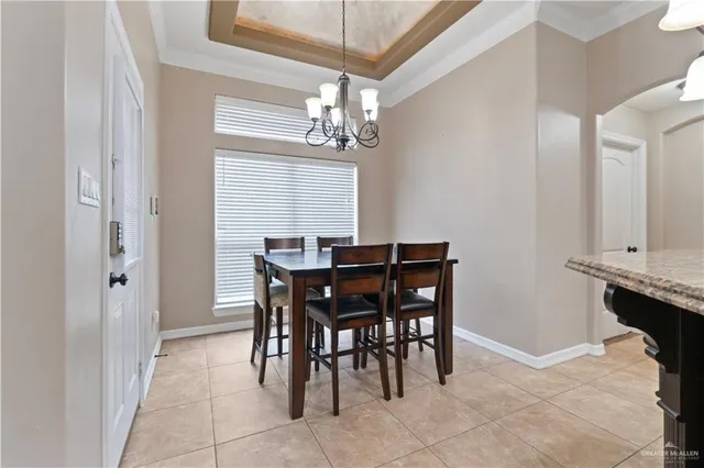 a view of a dining room with furniture and chandelier