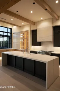 a large kitchen with stainless steel appliances a large counter top