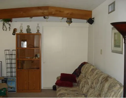 a living room with a bed and furniture