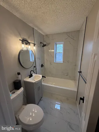 a bathroom with a toilet sink and bathtub