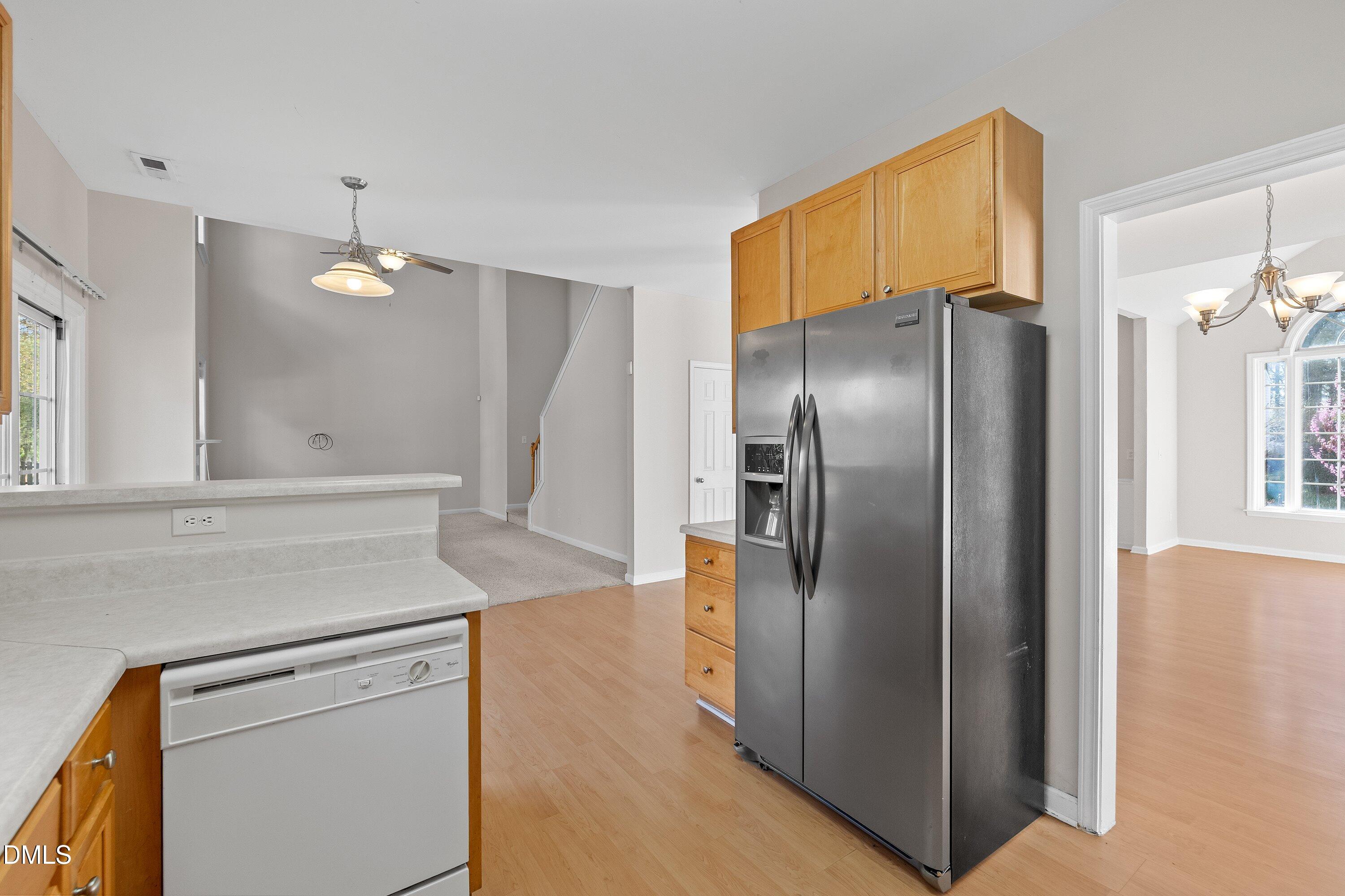 5717 Keowee Way Raleigh, NC 27616 - Photo 10 of 41 a kitchen with refrigerator cabinets and wooden floor