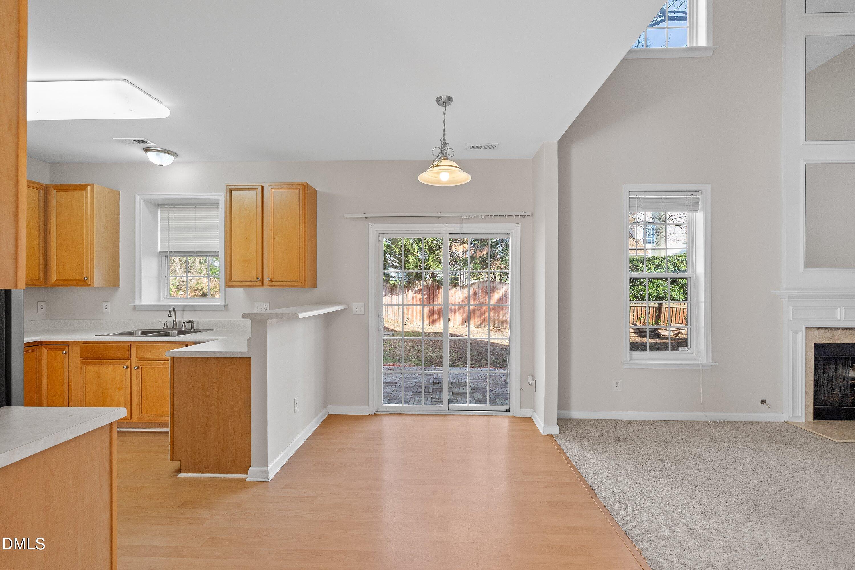 5717 Keowee Way Raleigh, NC 27616 - Photo 11 of 41 a view of a kitchen with wooden floor and a window