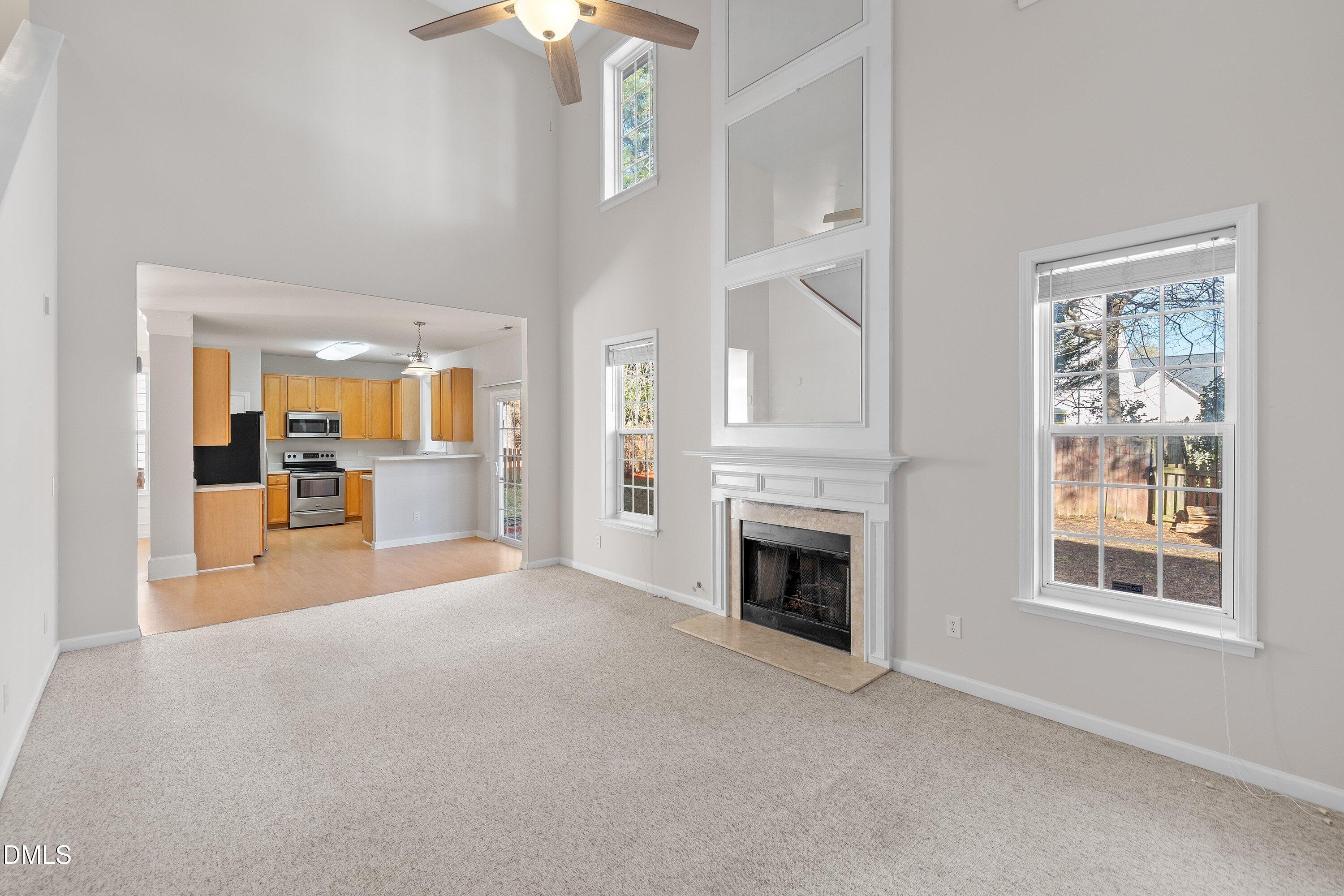 5717 Keowee Way Raleigh, NC 27616 - Photo 14 of 41 a view of empty room with a fireplace and large window