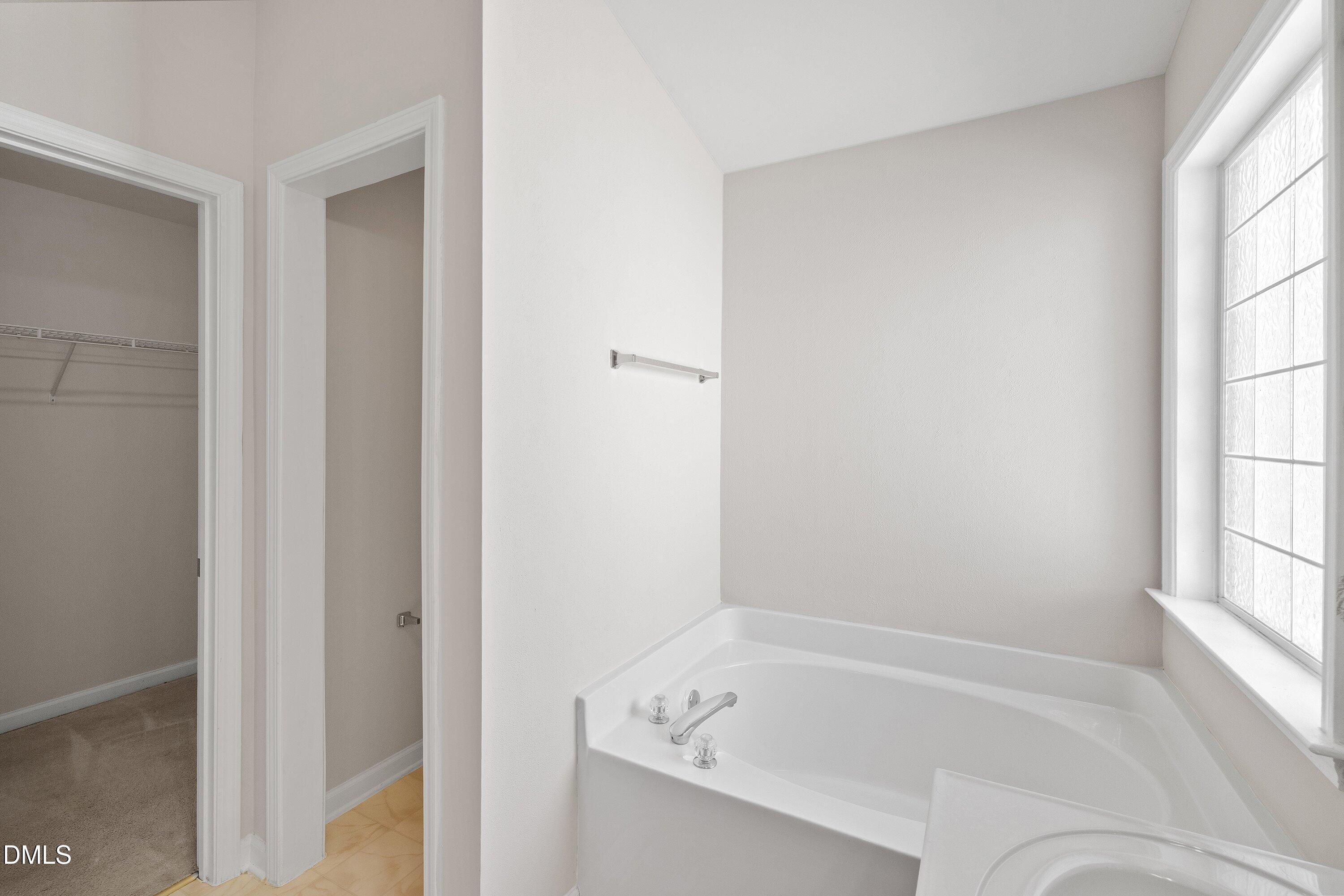 5717 Keowee Way Raleigh, NC 27616 - Photo 21 of 41 a white bath tub sitting next to a window